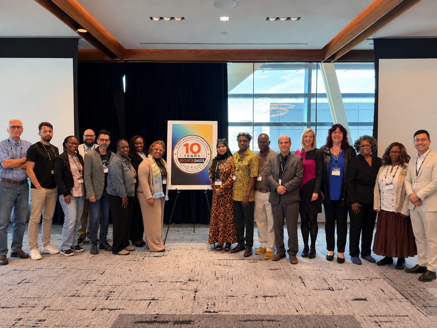 FacultyHack@Gateways 2026 participants and mentors together at the Gateways 2026 conference, held at The Johns Hopkins University Bloomberg Center in Washington, DC, beside the SGX3 | SGCI 10th Anniversary poster